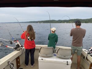 Dad is now reelin in a fish of his own because the family has hooked into a triple three fish on at the same time