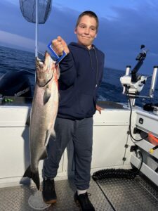 kid catches big fish on Manitou Passage fishing trip