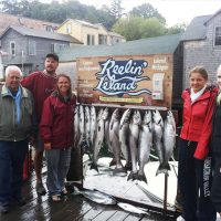 Family posing with the Reelin LeLand sign