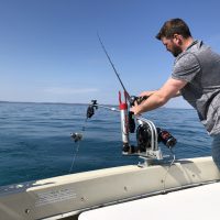 on-lake-michigan-sport-fishing-james-is-setting-big-jon-downrigger-for-king-salmon-and-lake-trout