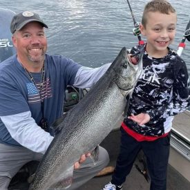 father and son on a Lake Michigan fishing trip with Reelin Leland Fishing Charters