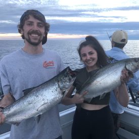 Couple showing off the fish they caught on Lake Michigan